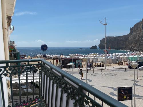 a balcony with a view of the beach and the ocean at BayView Nazaré in Nazaré