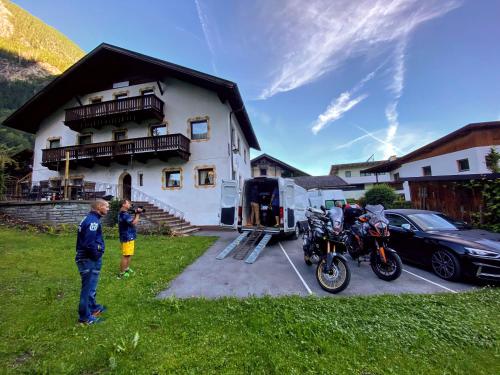 a group of people standing in front of a house at Haus Fiegl in Oetz