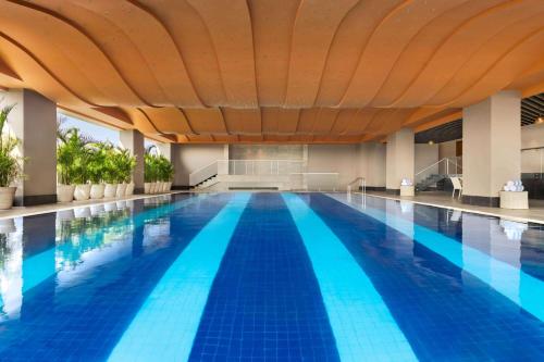 a large swimming pool with a large ceiling at Wyndham Chandigarh Mohali in Chandīgarh