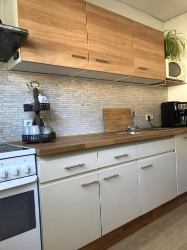 a kitchen with white cabinets and a stove top oven at Ferienwohnung Frevel in Pommern