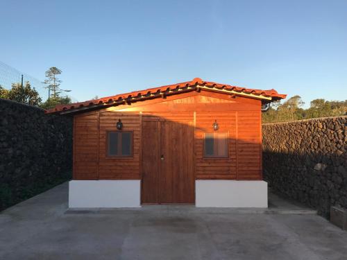 a small wooden shed with a gate and a fence at A Cabana in Angra do Heroísmo