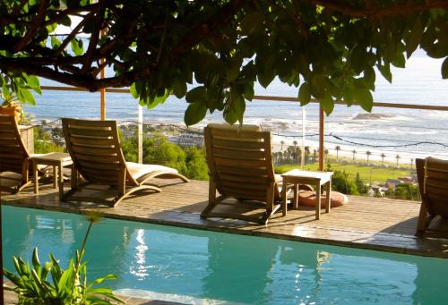 a group of chairs sitting next to a swimming pool at Boutique@10 in Cape Town