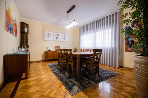 a dining room with a table and chairs at Green House - Douro in Peso da Régua