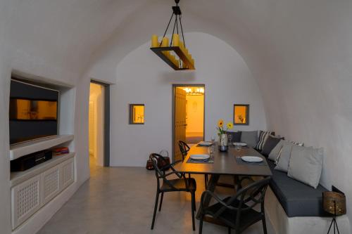 a living room with a table and a couch at MyBozer Cave Villa in Karterados