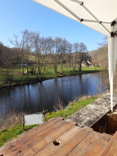 a view of a river from a wooden dock at Les Roches Chambre d'Hotes in Servant