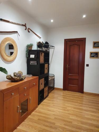 a living room with a wooden floor and a door at JÁNDALA in Unquera