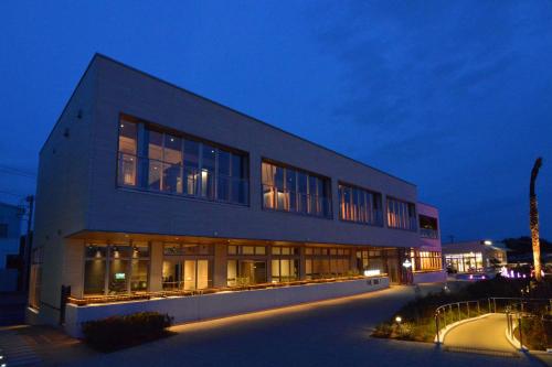 a large building at night with its lights on at Toriizaki Club HOTEL and SEAFOODS in Kisarazu