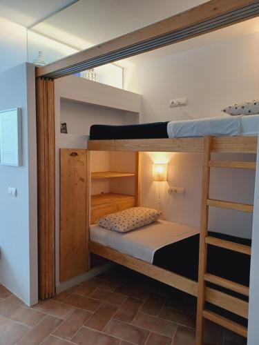a couple of bunk beds in a room at Apto en 1ra línea Carrer Les Voltes Parking Grátis in Calella de Palafrugell