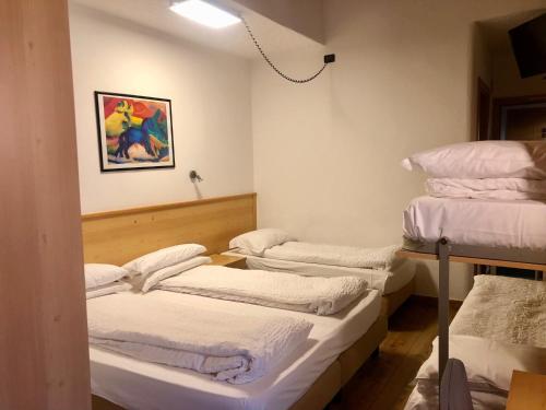 a room with four mattresses stacked on top of each other at Hotel Derby in Folgarida