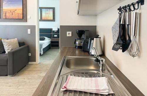 a kitchen with a sink and a counter top at PRIMA Inn Ferienwohnungen Seetor Residenz in Neuruppin