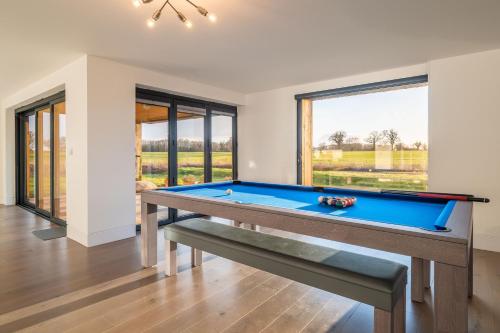 a pool table in a room with a large window at Mandalore in Blyford