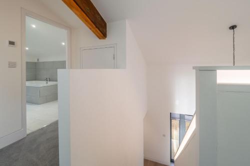 a bathroom with a white wall and a sink at Mandalore in Blyford