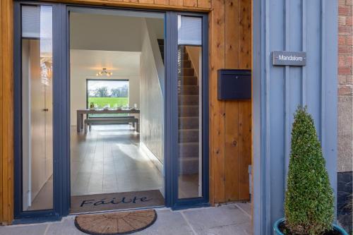 a glass door of a building with a table in the distance at Mandalore in Blyford