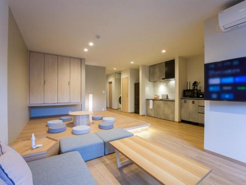 a living room with a table and a kitchen at Rakuten STAY Nikko Hoden No pets allowed Capacity of 8 persons with Cypress bath in Nikko