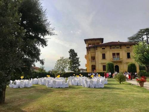 a row of tables and chairs in front of a building at Villa Moorings in Barga