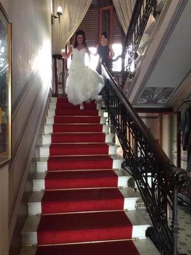 two women walking down a red and white stairs at Villa Moorings in Barga