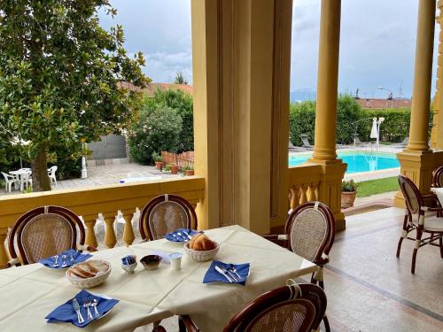 a dining room with a table and a view of a pool at Villa Moorings in Barga