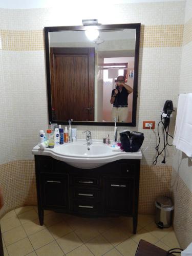 a person taking a picture of a bathroom sink at B&B Del Borgo in San Marco Argentano
