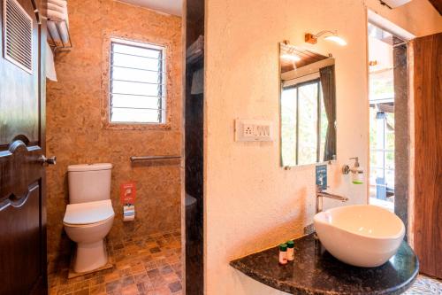 a bathroom with a toilet and a sink at Zostel Plus Lonavala in Lonavala