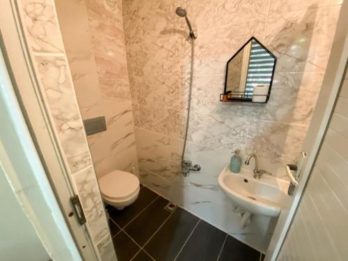 a bathroom with a toilet and a sink at CityHub in Antalya