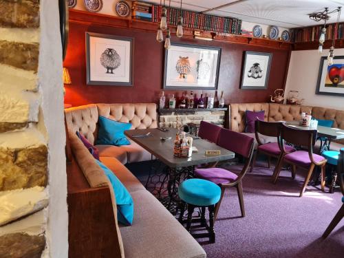 a restaurant with a table and chairs in a room at Bolton arms downholme in Richmond