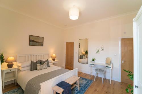 a bedroom with a bed and a desk at Foundry Farm Apartment in Hexham