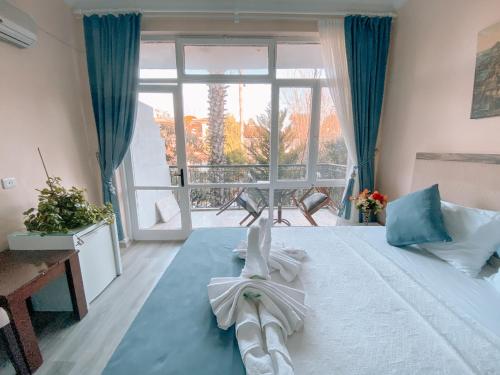 a bedroom with a bed with a towel on it at CityHub in Antalya