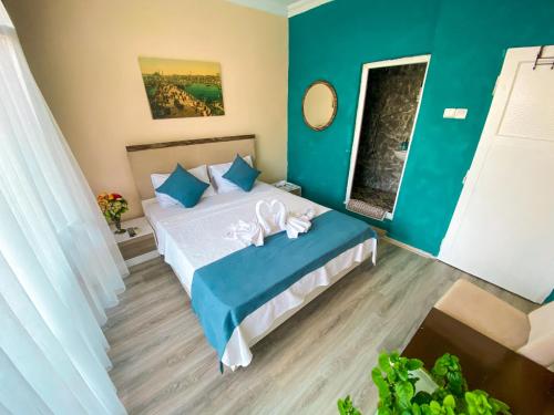 a bedroom with a bed with blue and green walls at CityHub in Antalya