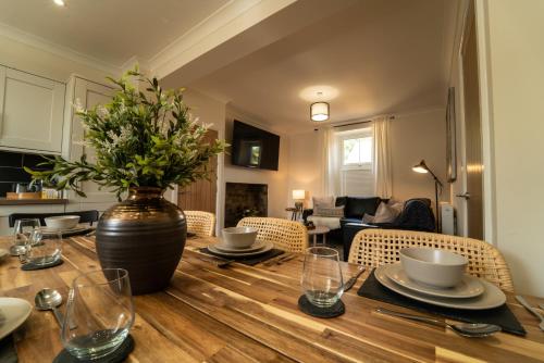 uma mesa de jantar com um vaso em cima em Foundry Farm House em Hexham