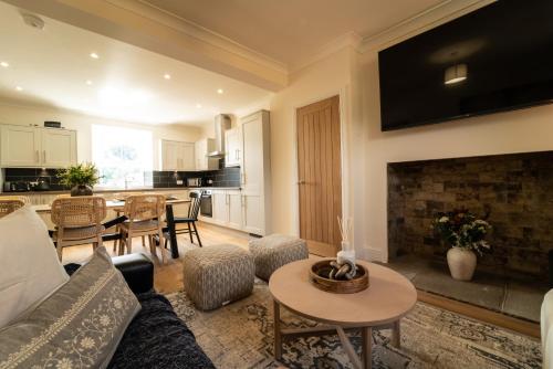 a living room with a couch and a fireplace at Foundry Farm House in Hexham