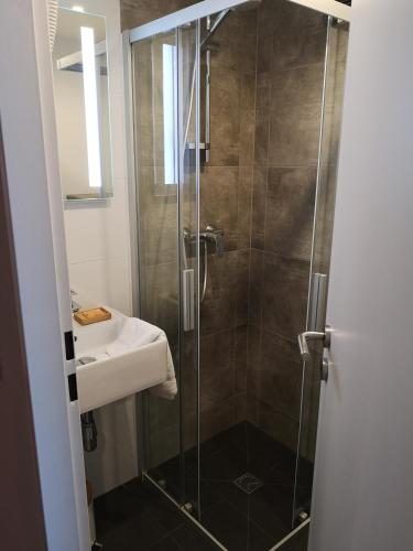 a bathroom with a shower and a sink at Hotel Spahr in Stuttgart