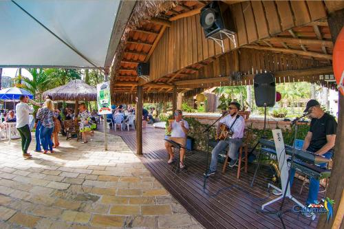 a group of people sitting outside of a building at Cabanas Termas Hotel in Gravatal
