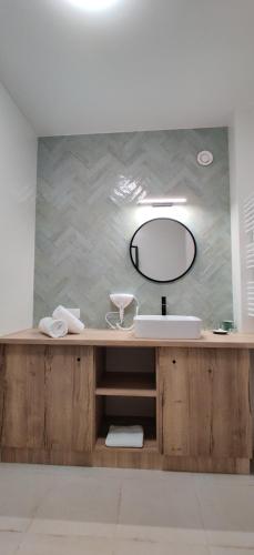 a bathroom with a sink and a mirror at 4 Kąty Apartamenty Koronowo in Koronowo