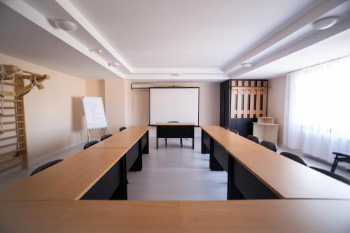 a conference room with desks and a white board at Hotel Alexandra in Timişoara