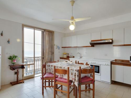 - une cuisine avec une table et des chaises offrant une vue sur l'océan dans l'établissement Belvilla by OYO Marinella House, à Marinella di Selinunte