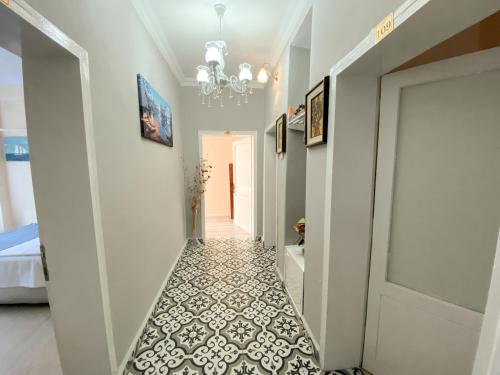 a hallway with a white and black tile floor at CityHub in Antalya