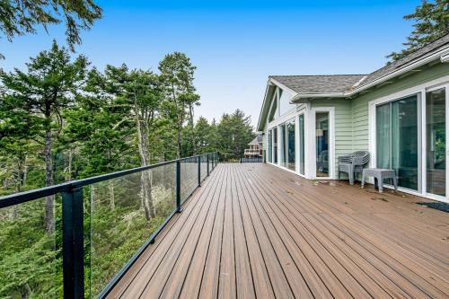a wooden deck on the side of a house at Capeside Paradise in Pacific City