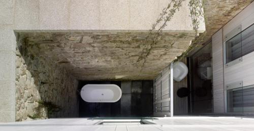 a wall with a tv on the side of a building at Moure Hotel in Santiago de Compostela