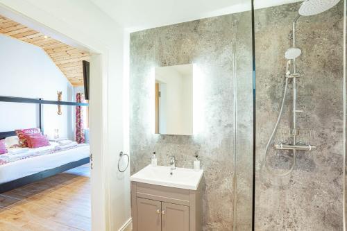 a bathroom with a shower and a sink and a shower at Kestrel Lodge 6 with Hot Tub in Newton Stewart