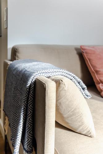 a bed with a blanket and pillows on it at Beautiful Apartments on Strøget in Copenhagen City Center in Copenhagen
