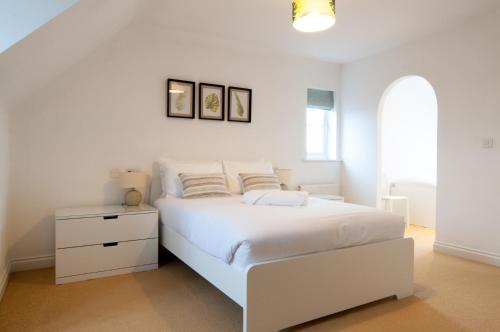 a white bedroom with a white bed and a window at Aztec House - Modern & Spacious, 6 separate beds in Derby