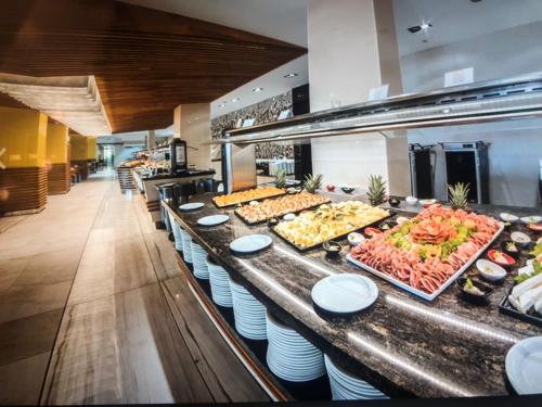 a buffet line with many different types of food at Private Apartment 49 in Prestige Fort Beach Hotel in Sveti Vlas