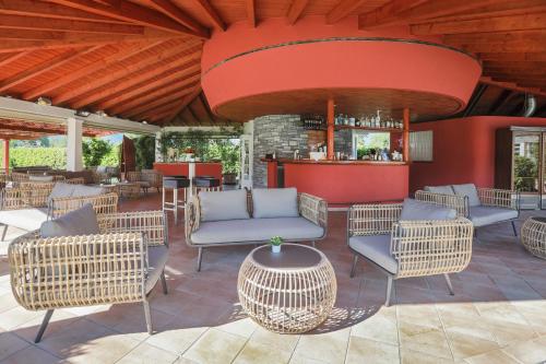 an outdoor patio with chairs and a bar at Parkhotel Delta, Wellbeing Resort in Ascona