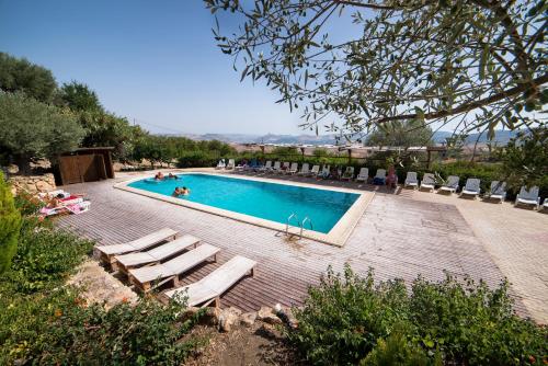a swimming pool with chaise lounge chairs at Principe di Aragona in Aragona