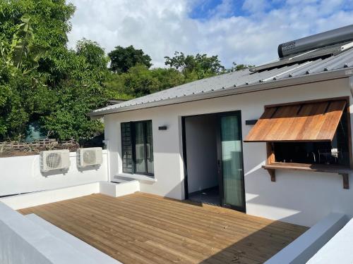 a deck on the side of a house at Villa Pwintosel 1, calme et confort à 300m de l'océan in Saint-Leu