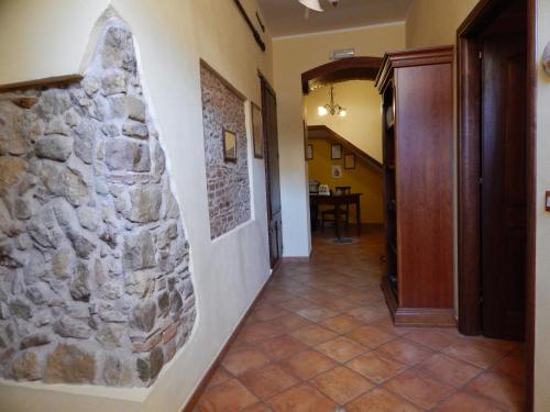 a hallway in a house with a stone wall at B&B Del Borgo in San Marco Argentano