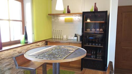 a room with a table and a shelf with wine bottles at Ferienwohnungen Familie Neubert in Nordheim