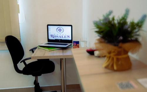 a laptop computer sitting on top of a table at Hotel Rosales Boutique in Neiva