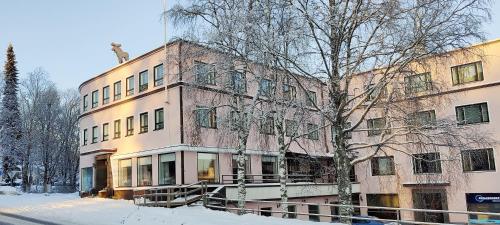 a building with a cat on top of it in the snow at Hotel Hirvi in Äänekoski