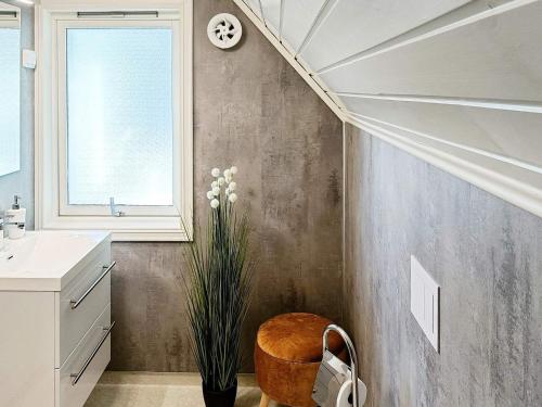 a bathroom with a stairway with a chair and a plant at Seaside Fisherman s Haven-By Traum in Steinsbø